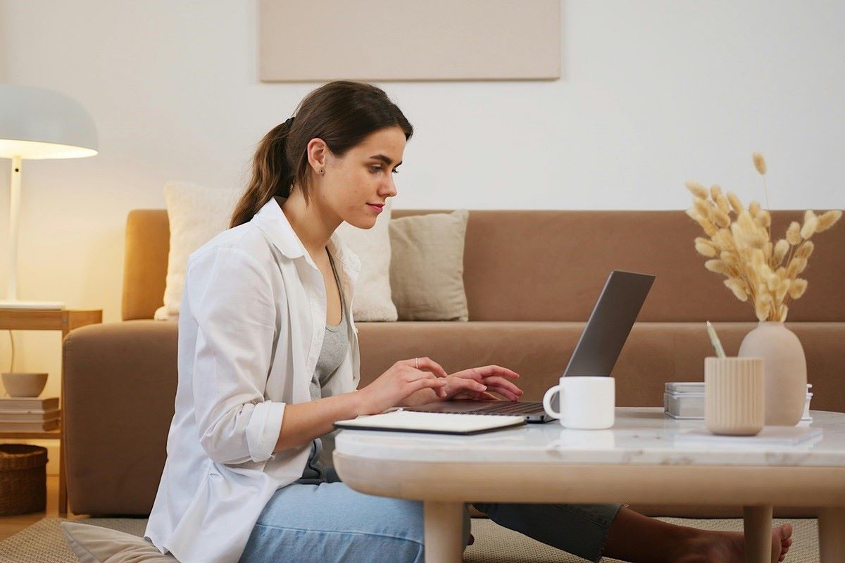Digital nomad working on laptop on table