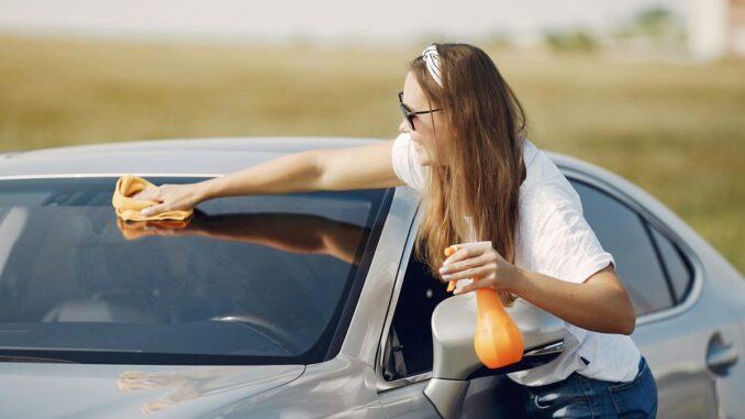Woman cleaning car