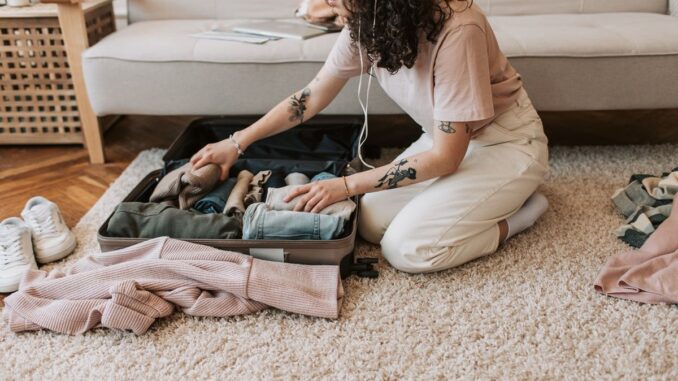 Girl packing clothes and gear