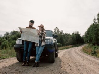 Reading map in front of overlander SUV